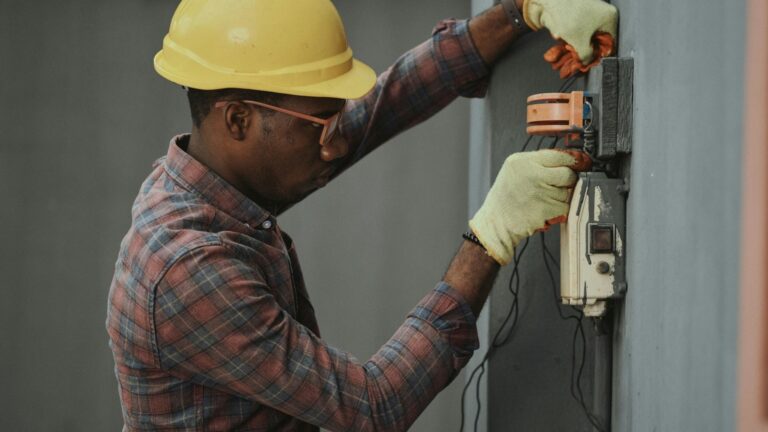 This image is about Electrician fixing some electrical issues